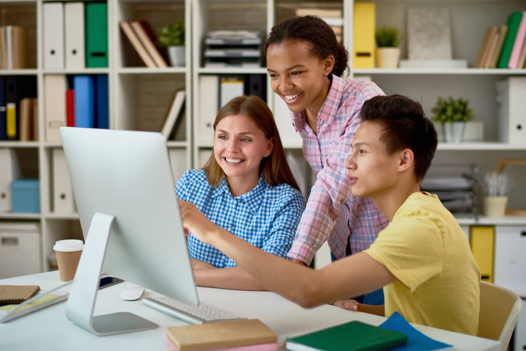 Smiling Students Working with Computer